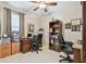 Office with two desks, office chairs, a bookcase, and a window at 1415 Millbrook Cir, Bradenton, FL 34212
