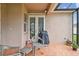 Cozy patio features tile flooring, a grill, and direct access to the home's interior at 1415 Millbrook Cir, Bradenton, FL 34212