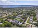 Aerial view showcasing a residence near a lake surrounded by mature trees and lush landscaping in a vibrant neighborhood at 1508 86Th Nw Ct, Bradenton, FL 34209