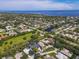 Expansive aerial view of home in a lush community close to the ocean, with a tranquil pond nearby at 1508 86Th Nw Ct, Bradenton, FL 34209