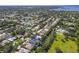 Aerial view of a home nestled in a beautiful community, surrounded by lush greenery and a peaceful pond at 1508 86Th Nw Ct, Bradenton, FL 34209