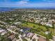 Aerial view of home in a lush neighborhood, complete with verdant foliage, a pond, and wide green spaces at 1508 86Th Nw Ct, Bradenton, FL 34209