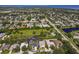 Aerial view of a beautiful home located in a lush neighborhood, situated next to a green field at 1508 86Th Nw Ct, Bradenton, FL 34209