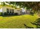 Picture of a manicured lawn with home exterior and enclosed lanai, framed by trees and landscaping at 1508 86Th Nw Ct, Bradenton, FL 34209