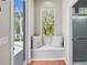 Hallway featuring a window seat, doorway to the pool area and doorway to the bathroom at 1508 86Th Nw Ct, Bradenton, FL 34209