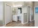 Bright bathroom features a white vanity with marble countertop and wood-look tile flooring at 1508 86Th Nw Ct, Bradenton, FL 34209