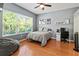 Relaxing bedroom with hardwood floors, large window, ceiling fan, and neutral decor at 1508 86Th Nw Ct, Bradenton, FL 34209