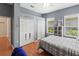 Bedroom featuring hardwood floors, a ceiling fan, a window view, gray walls and two closets at 1508 86Th Nw Ct, Bradenton, FL 34209