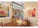 Open dining area with hardwood floors, contemporary light fixture, and view into the living room at 1508 86Th Nw Ct, Bradenton, FL 34209