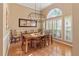 Elegant dining room with hardwood floors, stylish light fixture, and large window providing natural light at 1508 86Th Nw Ct, Bradenton, FL 34209