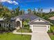 Charming single-story home featuring a manicured lawn, beautiful landscaping, and a two-car garage at 1508 86Th Nw Ct, Bradenton, FL 34209