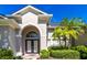 Close-up view of the home's arched entry, framed by manicured landscaping and a brick-paved entrance at 1508 86Th Nw Ct, Bradenton, FL 34209