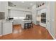 Bright kitchen boasts white cabinets, stainless steel appliances, central island and hardwood floors at 1508 86Th Nw Ct, Bradenton, FL 34209