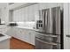Close up of kitchen area featuring white cabinets and modern stainless steel refrigerator at 1508 86Th Nw Ct, Bradenton, FL 34209