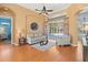 Open living room featuring hardwood floors, neutral décor, and a sliding glass door leading to the pool area at 1508 86Th Nw Ct, Bradenton, FL 34209