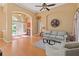 Bright and airy living room featuring hardwood floors, comfortable seating, and a view into the foyer at 1508 86Th Nw Ct, Bradenton, FL 34209