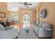 Spacious living room with hardwood floors, comfortable seating, and open access to the dining area at 1508 86Th Nw Ct, Bradenton, FL 34209