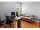Office with hardwood floors, an office desk, office chair, and a taupe sofa at 1508 86Th Nw Ct, Bradenton, FL 34209