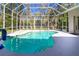 Sparkling screened-in pool with lush landscaping and a basketball hoop, perfect for backyard fun at 1508 86Th Nw Ct, Bradenton, FL 34209