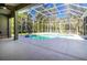 Large screened-in pool surrounded by a concrete patio and lush landscaping, providing a private oasis at 1508 86Th Nw Ct, Bradenton, FL 34209