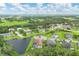 An aerial view of a desirable community with mature landscaping, pond views, and well-maintained homes at 16038 39Th E Gln, Parrish, FL 34219