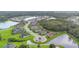 Aerial view of neighborhood shows homes on well-manicured lots with neighborhood ponds and mature tree growth at 16038 39Th E Gln, Parrish, FL 34219