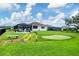 Enjoy the scenic backyard with a putting green, fire pit, and screened-in porch at 16038 39Th E Gln, Parrish, FL 34219