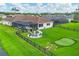 Lush backyard features a putting green, covered lanai, and a screened in pool, perfect for entertaining at 16038 39Th E Gln, Parrish, FL 34219