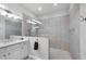 Modern bathroom featuring a glass-enclosed shower with gray tiling, and a single sink vanity with white cabinets at 16038 39Th E Gln, Parrish, FL 34219