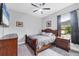 Bedroom boasts a ceiling fan, wood furniture, and a large window to allow natural light at 16038 39Th E Gln, Parrish, FL 34219
