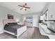 This charming bedroom includes a kitchenette and a light and bright painted wood bed frame at 16038 39Th E Gln, Parrish, FL 34219