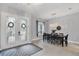 Formal dining room features a modern chandelier, a large dining table, and decorative french doors at 16038 39Th E Gln, Parrish, FL 34219