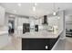 Well-equipped kitchen with an island, white cabinetry, stainless steel appliances, and modern lighting at 16038 39Th E Gln, Parrish, FL 34219
