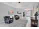Inviting living room features tile flooring, recessed lighting, and comfortable black leather recliners at 16038 39Th E Gln, Parrish, FL 34219