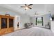Spacious living room with tray ceilings, ceiling fans, and a comfortable gray loveseat at 16038 39Th E Gln, Parrish, FL 34219
