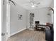 Cozy office space with wood floors, ceiling fan, desk, bookcase, and a window for natural light at 16038 39Th E Gln, Parrish, FL 34219