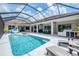 This beautiful pool features an outdoor dining area and outdoor kitchen, making it perfect for entertaining at 16038 39Th E Gln, Parrish, FL 34219