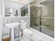Cozy bathroom with white fixtures, a pedestal sink, and a glass-enclosed shower, creating a clean and functional space at 200 Cocoanut Ave # 1, Sarasota, FL 34236