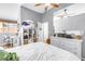 Bedroom with white bedding, a ceiling fan, and ample natural light at 200 Cocoanut Ave # 1, Sarasota, FL 34236