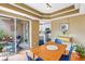Dining room with adjacent courtyard, visible through sliding glass doors, and modern decor at 200 Cocoanut Ave # 1, Sarasota, FL 34236