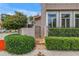 Brick pathway leading to a secure metal gate, offering a private entrance with lush green hedges and garden wall at 200 Cocoanut Ave # 1, Sarasota, FL 34236
