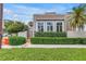 Charming home exterior featuring a well-manicured hedge and secure black metal fence, blending privacy with curb appeal at 200 Cocoanut Ave # 1, Sarasota, FL 34236