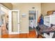 Hallway leading to a bathroom, featuring neutral walls, hardwood floors, and natural light at 200 Cocoanut Ave # 1, Sarasota, FL 34236