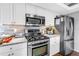 Modern kitchen features stainless steel appliances, gas range, sleek countertops, and white cabinetry for a clean aesthetic at 200 Cocoanut Ave # 1, Sarasota, FL 34236