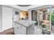 Kitchen island featuring granite countertop with access to outdoor courtyard through sliding glass doors at 200 Cocoanut Ave # 1, Sarasota, FL 34236