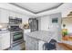 Well-lit kitchen boasts stainless steel appliances, gas range, granite countertops, and breakfast bar seating for casual dining at 200 Cocoanut Ave # 1, Sarasota, FL 34236