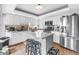 Bright kitchen features white cabinets, stainless steel appliances, granite countertops, and center island with seating at 200 Cocoanut Ave # 1, Sarasota, FL 34236