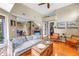 Inviting living room with warm hardwood floors, comfortable seating, and a charming fireplace at 200 Cocoanut Ave # 1, Sarasota, FL 34236