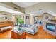 Bright living room featuring hardwood floors, a cozy fireplace, and a comfortable gray sofa at 200 Cocoanut Ave # 1, Sarasota, FL 34236
