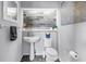 Stylish powder room with modern fixtures, a pedestal sink, and tasteful decor at 200 Cocoanut Ave # 1, Sarasota, FL 34236
